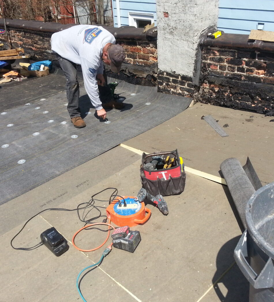 Am-Cat’s process of installing a flat roof system is performed by licensed roofers.